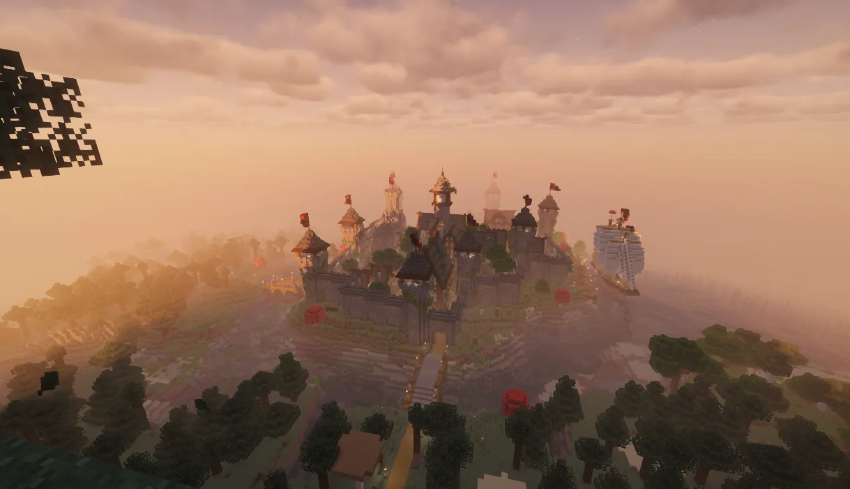 A walled town on a hill at sunset
